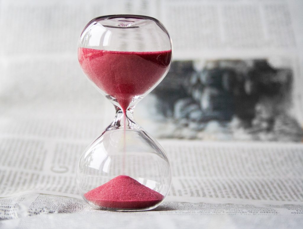 hour glass filled with red sand